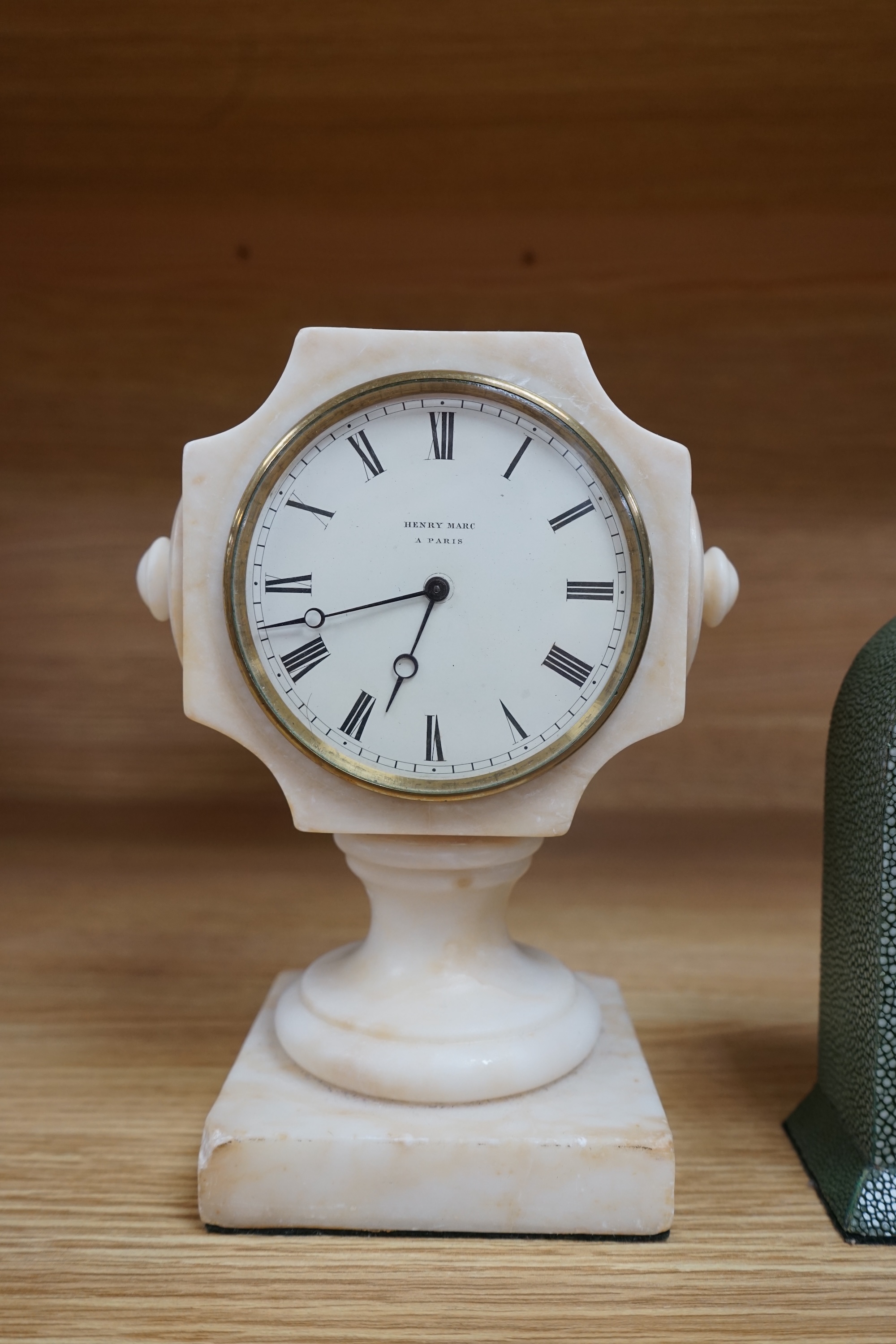 Three small mantel timepieces including a Tudric pewter timepiece, and a French timepiece in an alabaster case, signed Henry Marc, Paris. Condition - fair to good.